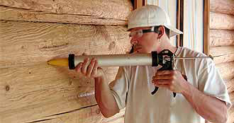 Caulking a log home with Energy Seal by Perma-Chink